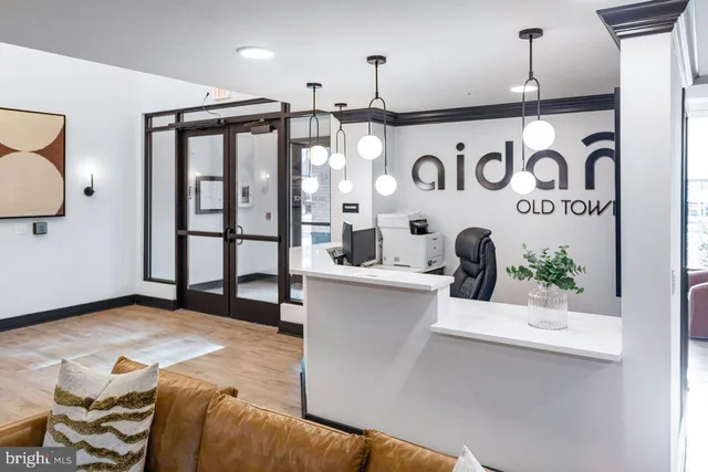 a kitchen with stainless steel appliances kitchen island granite countertop a refrigerator a sink and white cabinets