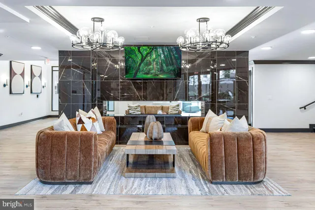 a living room with furniture and a chandelier
