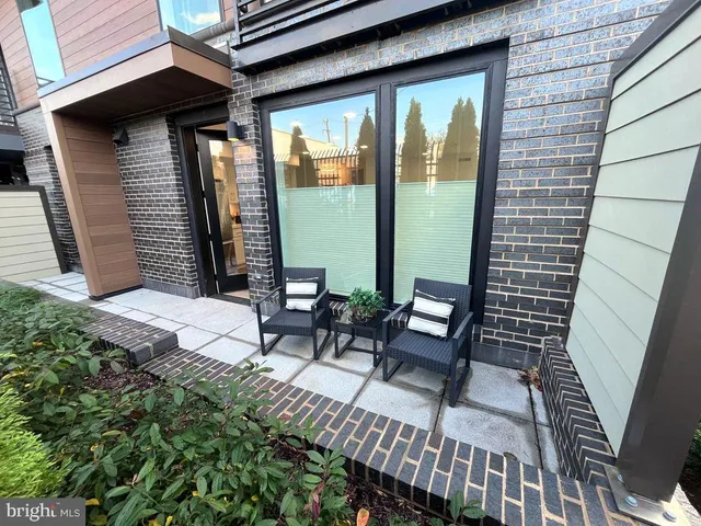 a view of a patio with a table and chairs
