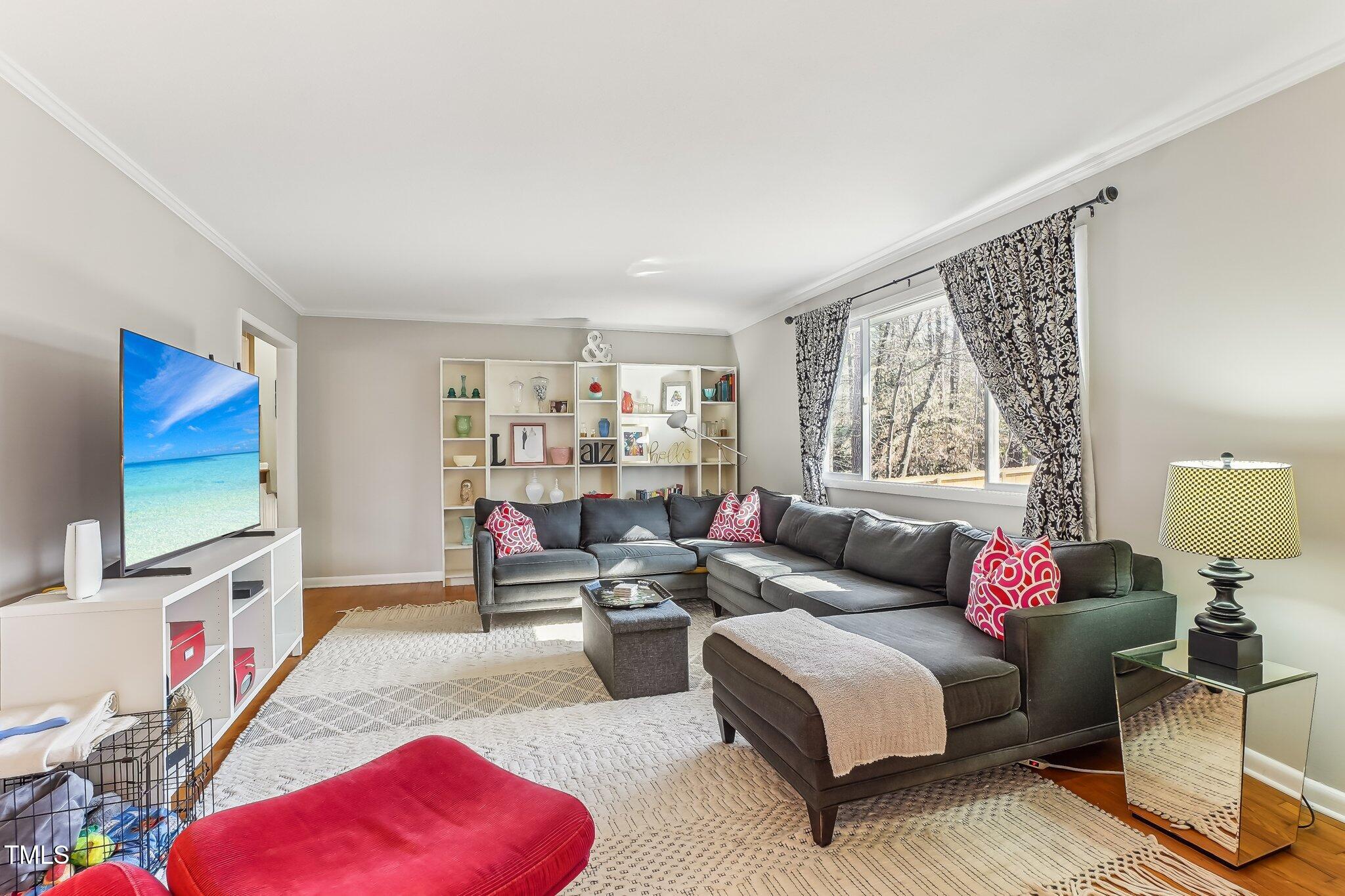 5410 Thayer Drive Raleigh, NC 27612 - Photo 12 of 36 a living room with furniture a rug and a window