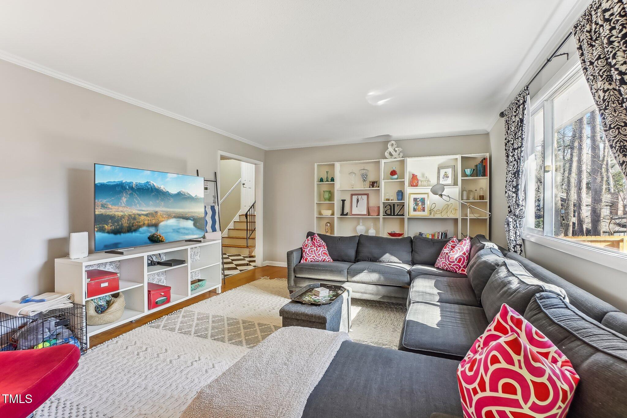 5410 Thayer Drive Raleigh, NC 27612 - Photo 13 of 36 a living room with furniture and a flat screen tv