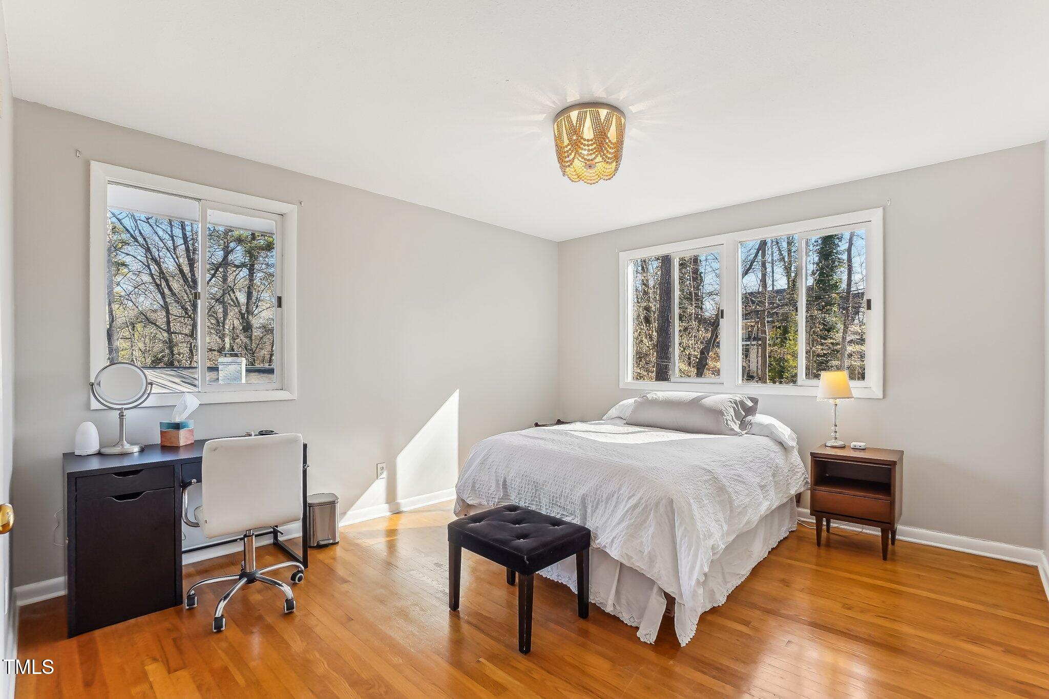 5410 Thayer Drive Raleigh, NC 27612 - Photo 19 of 36 a bedroom with a bed and wooden floor