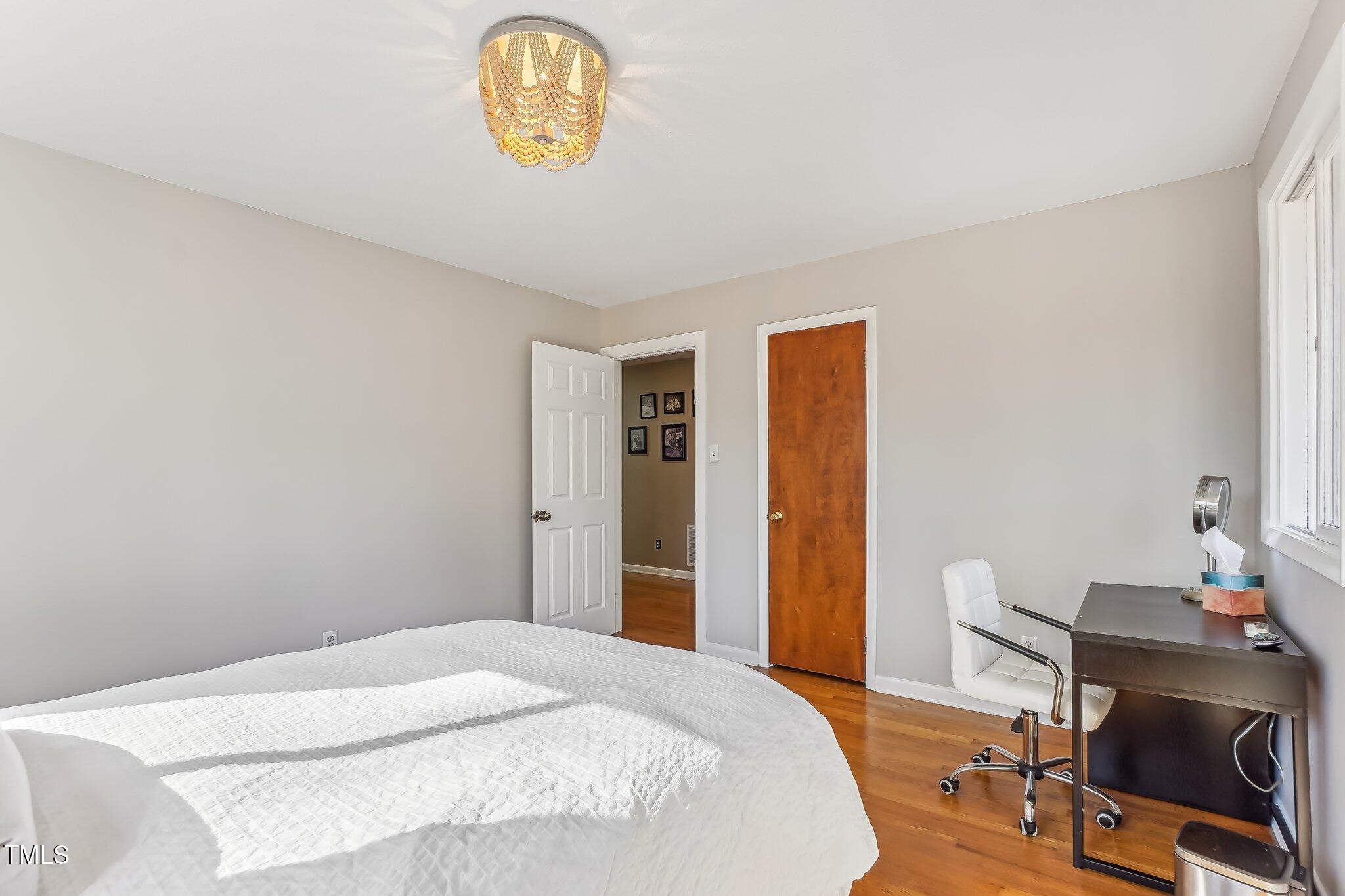 5410 Thayer Drive Raleigh, NC 27612 - Photo 20 of 36 a bedroom with a bed and a table in it