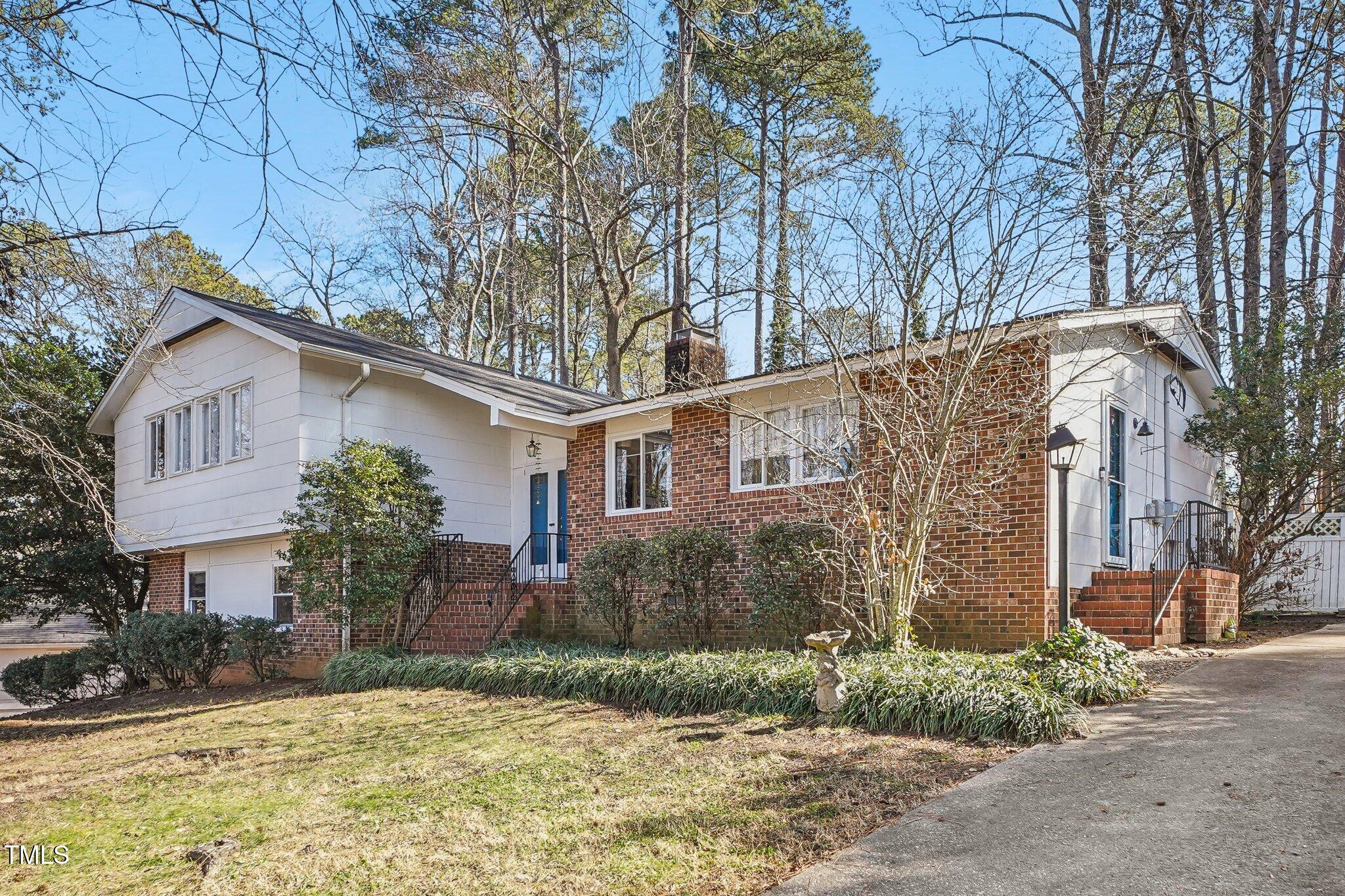 5410 Thayer Drive Raleigh, NC 27612 - Photo 2 of 36 a front view of a house with a yard and garage