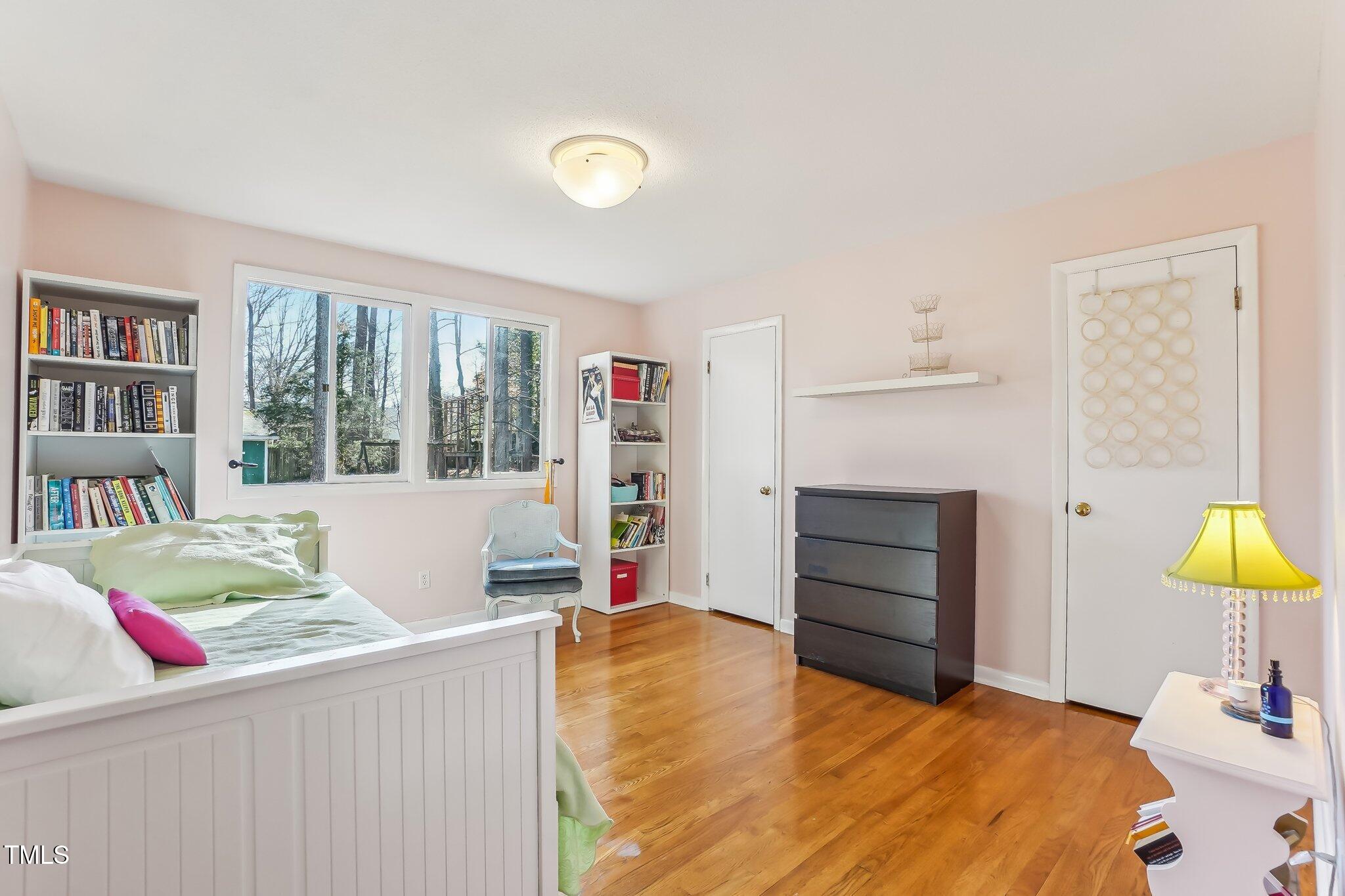 5410 Thayer Drive Raleigh, NC 27612 - Photo 21 of 36 a bedroom with a bed and a window