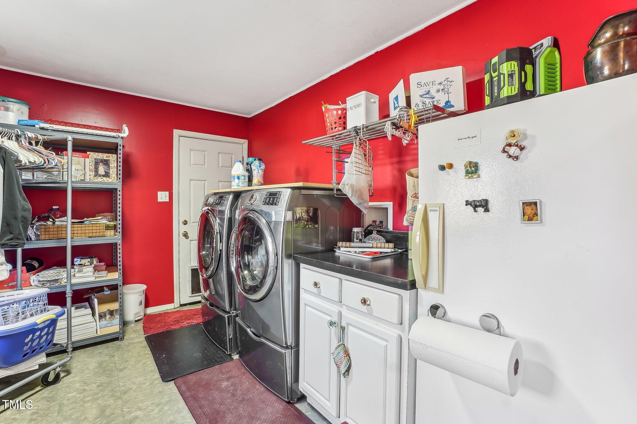 5410 Thayer Drive Raleigh, NC 27612 - Photo 30 of 36 a utility room with fridge dryer and washer