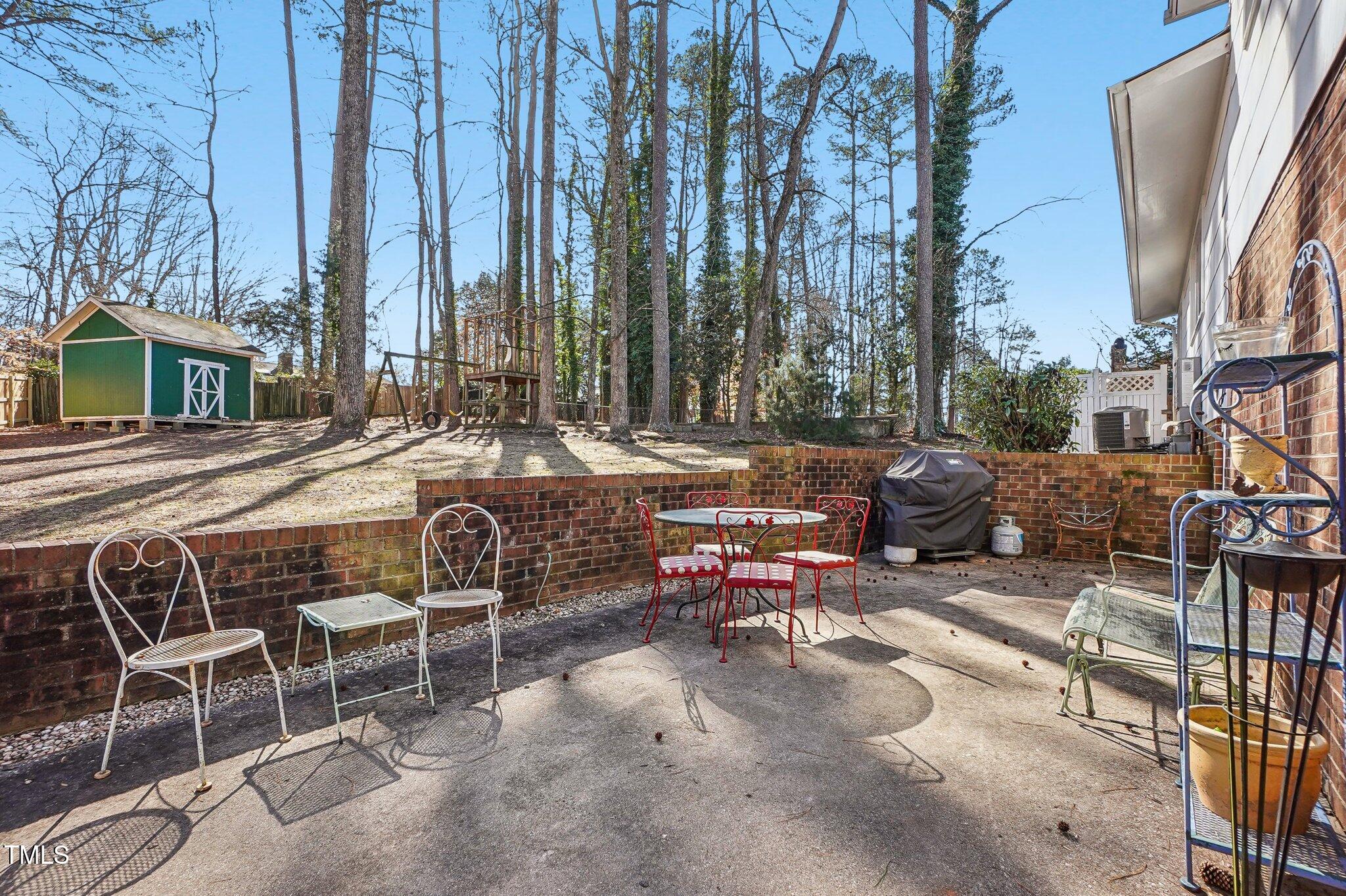 5410 Thayer Drive Raleigh, NC 27612 - Photo 31 of 36 a view of backyard with table and chairs and wooden fence