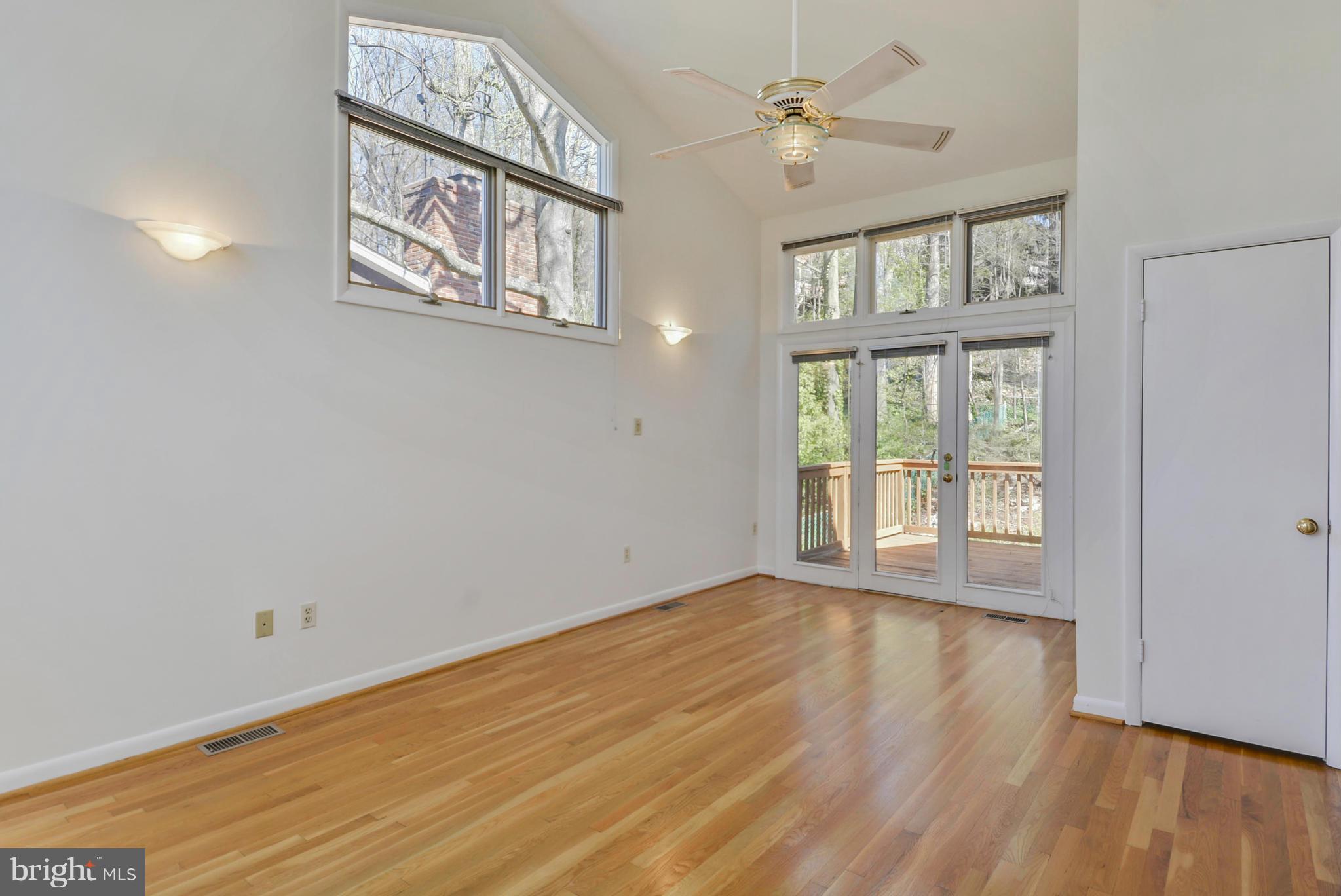 7701 Beech Tree Road Bethesda, MD 20817 - Photo 14 of 30 a view of an empty room with a window and wooden floor