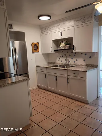 a view of a porch with a table chairs and potted plants