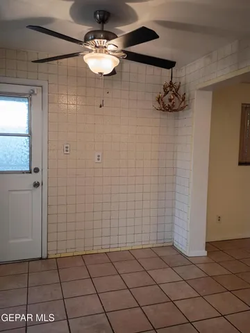 a living room with patio furniture and a flat screen tv