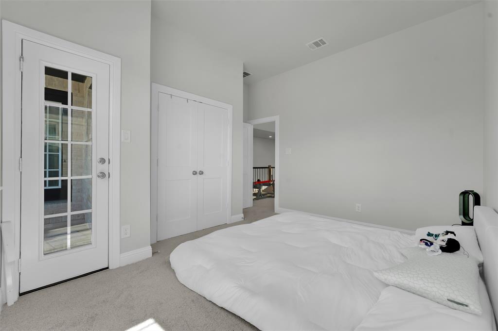 3520 Helios Lane Corinth, TX 76208 - Photo 28 of 37 Light gray wall paint with white trim, French door with multiple glass panes, carpeted flooring, and white bifold closet doors