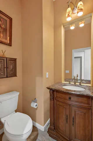 a kitchen with stainless steel appliances granite countertop a sink stove refrigerator and cabinets