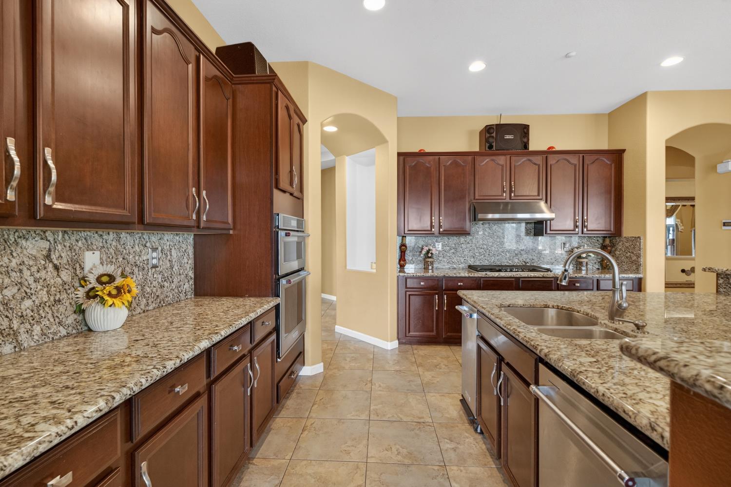 9601 Stablegate Road Wilton, CA 95693 - Photo 18 of 92 a kitchen with stainless steel appliances granite countertop a sink stove and refrigerator