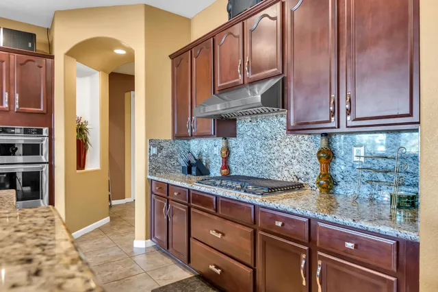 a bathroom with a granite countertop sink and a bathtub