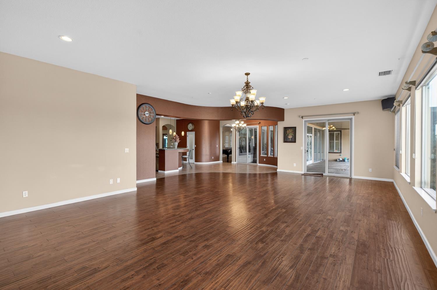 9601 Stablegate Road Wilton, CA 95693 - Photo 27 of 92 a view of a big room with wooden floor chandelier and windows