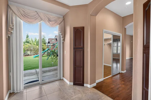 a bathroom with a granite countertop double vanity sink and a mirror