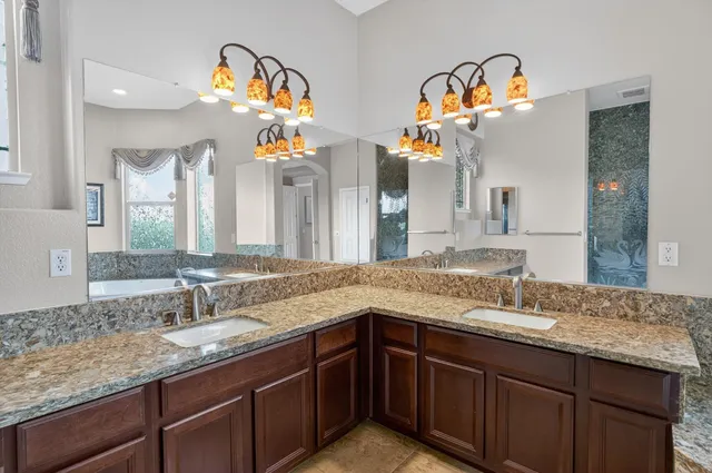 a bathroom with a sink vanity and a mirror
