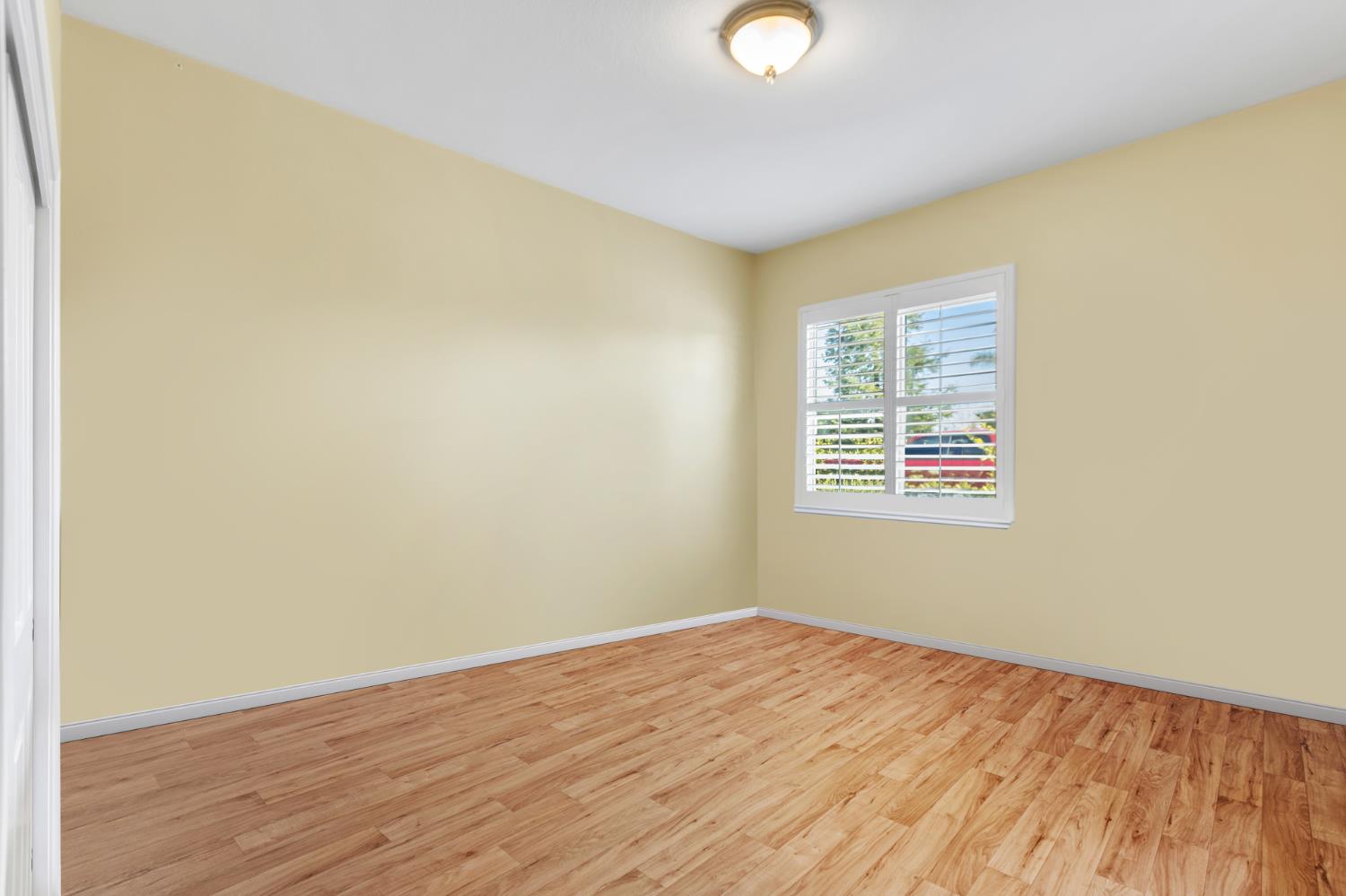 9601 Stablegate Road Wilton, CA 95693 - Photo 44 of 92 an empty room with wooden floor and windows