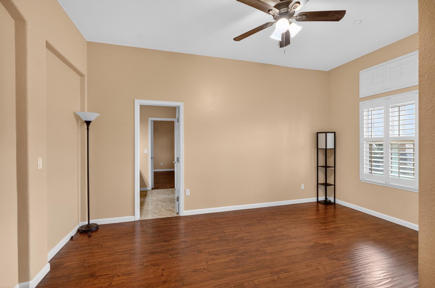 9601 Stablegate Road Wilton, CA 95693 - Photo 46 of 92 a view of an empty room with wooden floor and a window