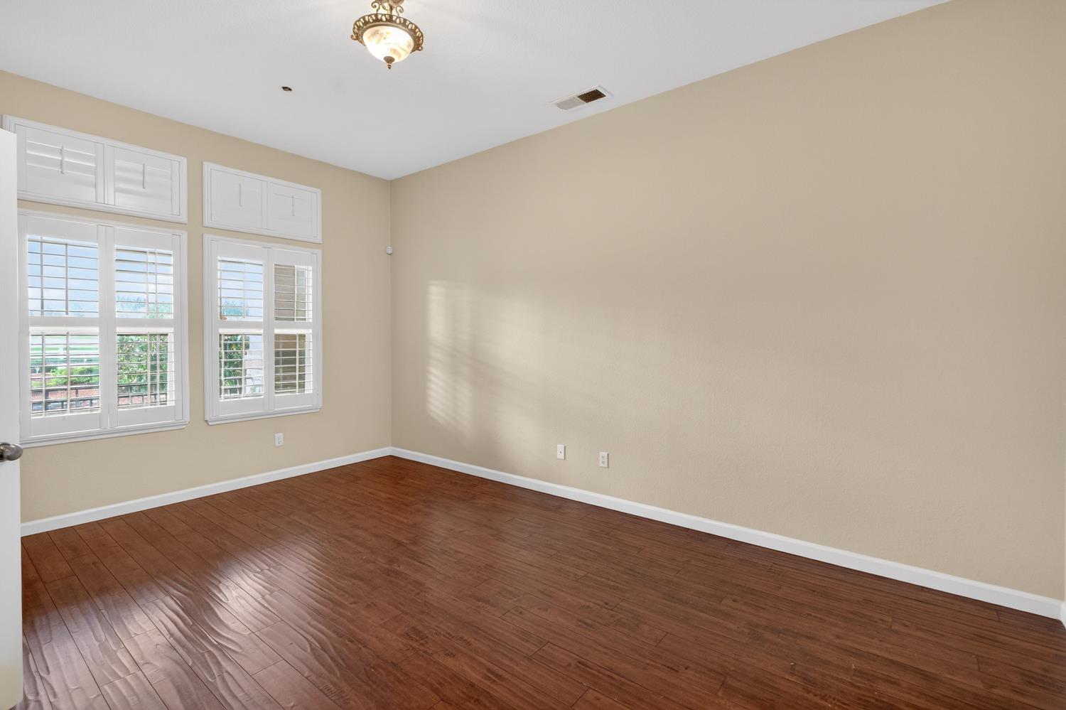 9601 Stablegate Road Wilton, CA 95693 - Photo 49 of 92 a view of an empty room with wooden floor and a window