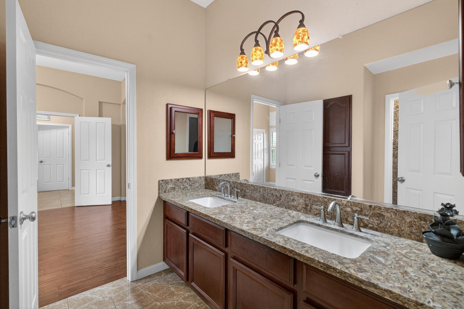 9601 Stablegate Road Wilton, CA 95693 - Photo 51 of 92 a bathroom with a granite countertop double vanity sink and a mirror
