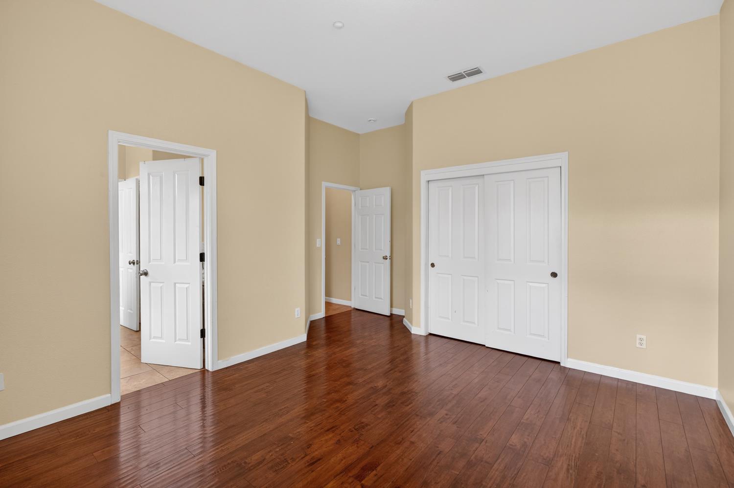 9601 Stablegate Road Wilton, CA 95693 - Photo 62 of 92 a view of an empty room with wooden floor