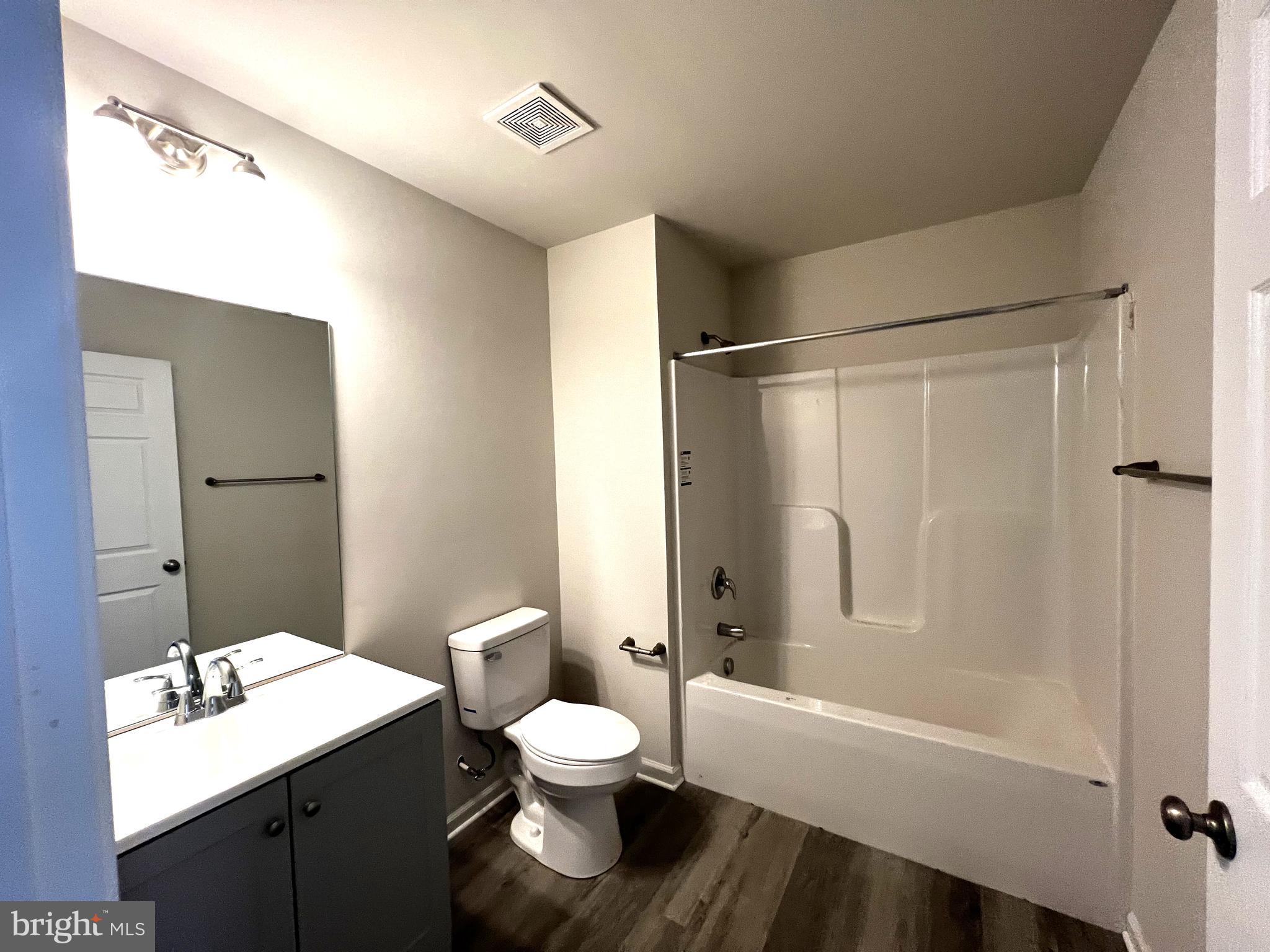 100 North 6th Street, Unit 100 Denton, MD 21629 - Photo 10 of 10 a bathroom with a bathtub shower sink vanity and a toilet