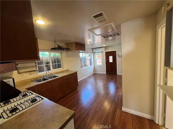 a kitchen with stainless steel appliances granite countertop a stove and wooden floor