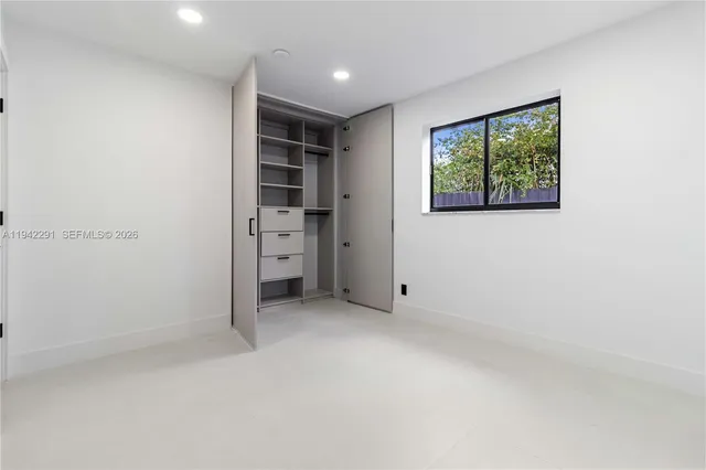 an empty room with closet area