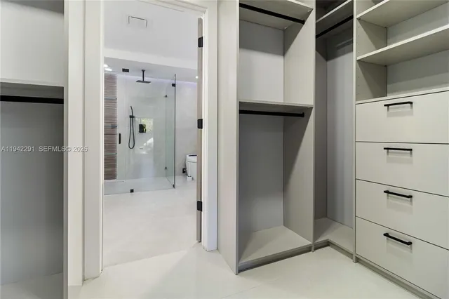 a bathroom with a shower and a glass door