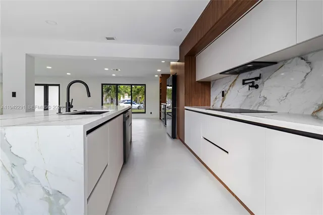 a view of a kitchen with a sink and cabinets