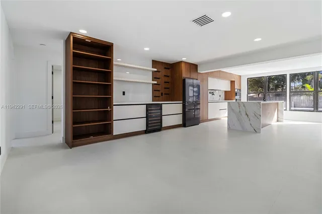 a view of kitchen with furniture and windows