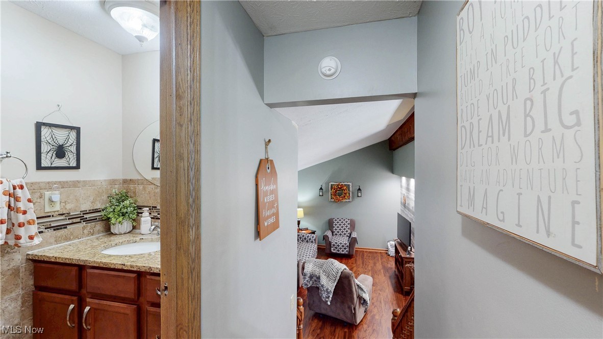 3123 Clearview Road Ravenna, OH 44266 - Photo 26 of 44 Corridor featuring dark wood-style floors, lofted ceiling, and a textured ceiling