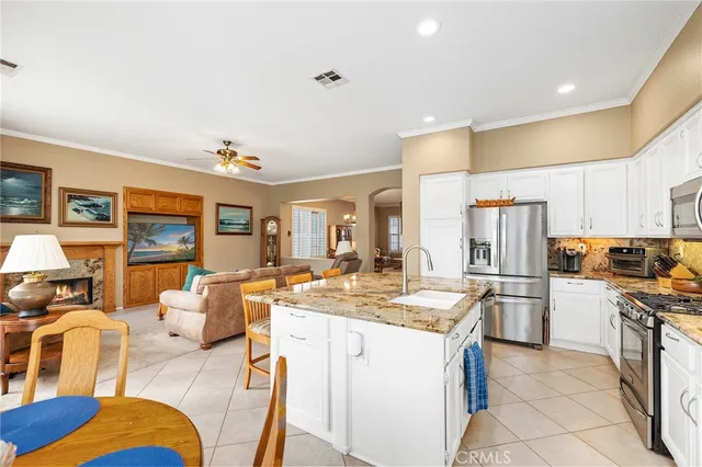 a kitchen with stainless steel appliances granite countertop a sink and cabinets