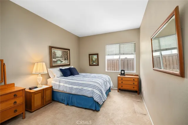 a bedroom with a bed couch and window