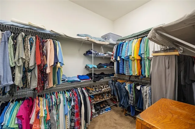 a view of walk in closet with clothes