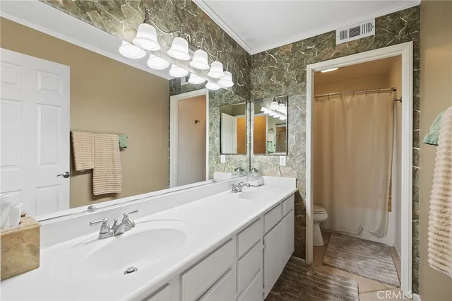 a spacious bathroom with a double vanity sink mirror and