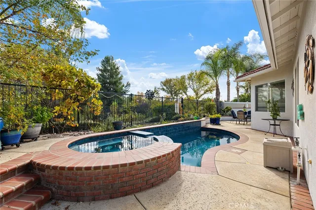 a view of swimming pool with seating space