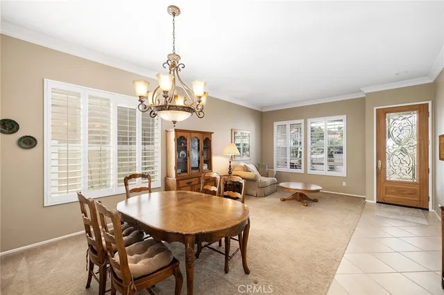 a dining room with a large window table and chairs