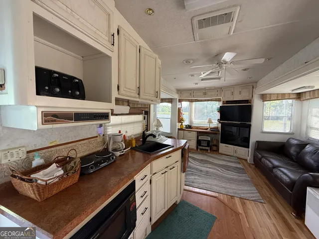 a kitchen with stainless steel appliances granite countertop a stove and cabinets