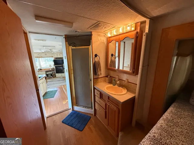 a bathroom with a sink a mirror and a shower