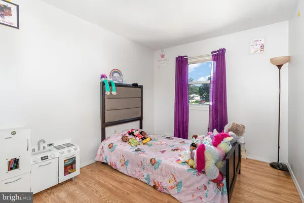 a bedroom with a bed and a dresser in it