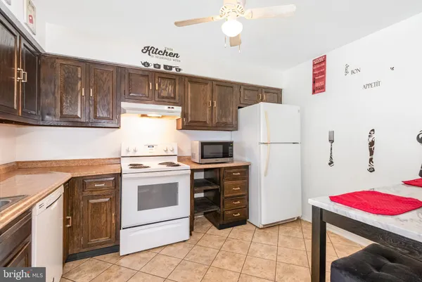 a kitchen with a stove a refrigerator and a sink