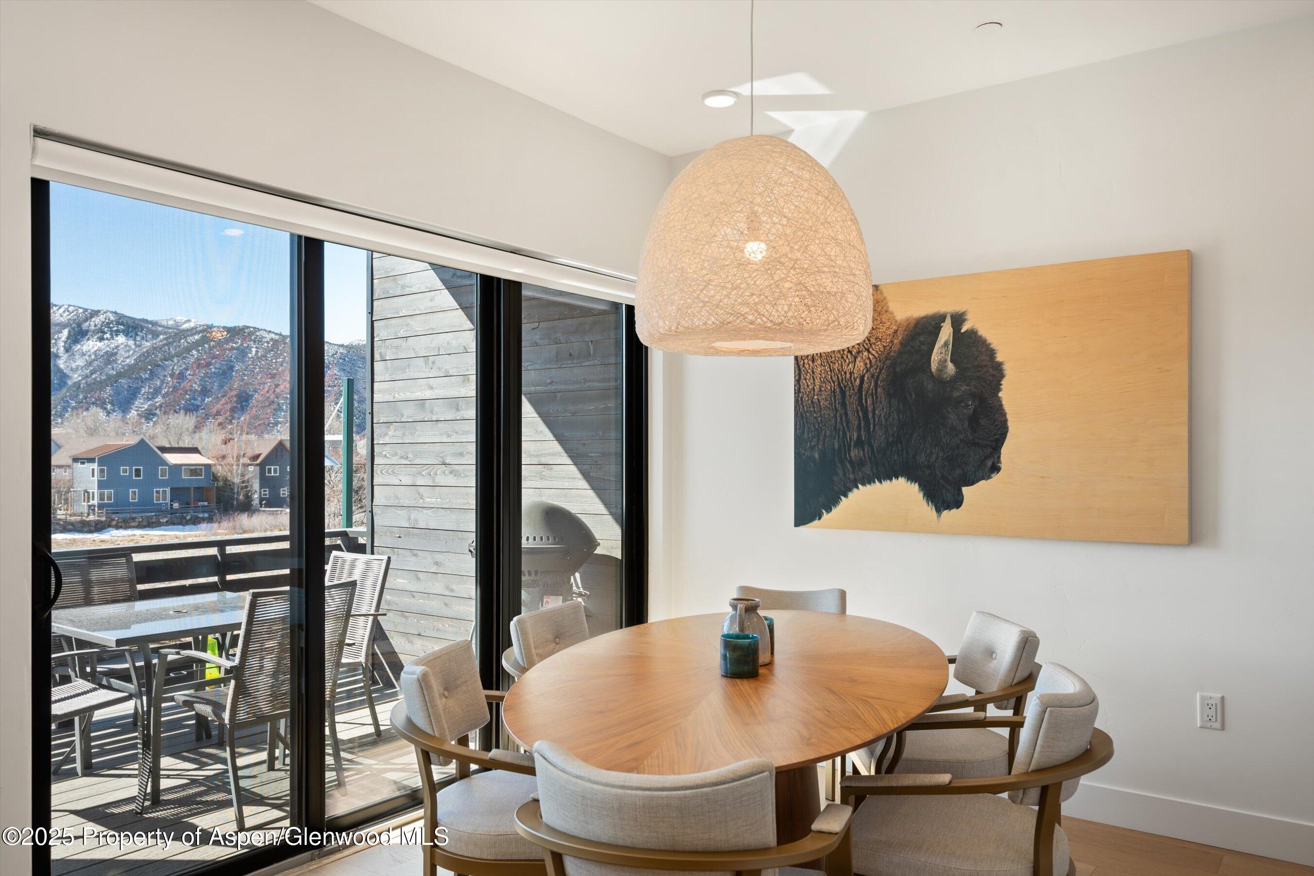 220 Lewis Lane Basalt, CO 81621 - Photo 11 of 32 a view of a dining room with furniture and wooden floor
