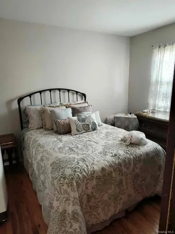 a large bed sitting in a bedroom next to a window