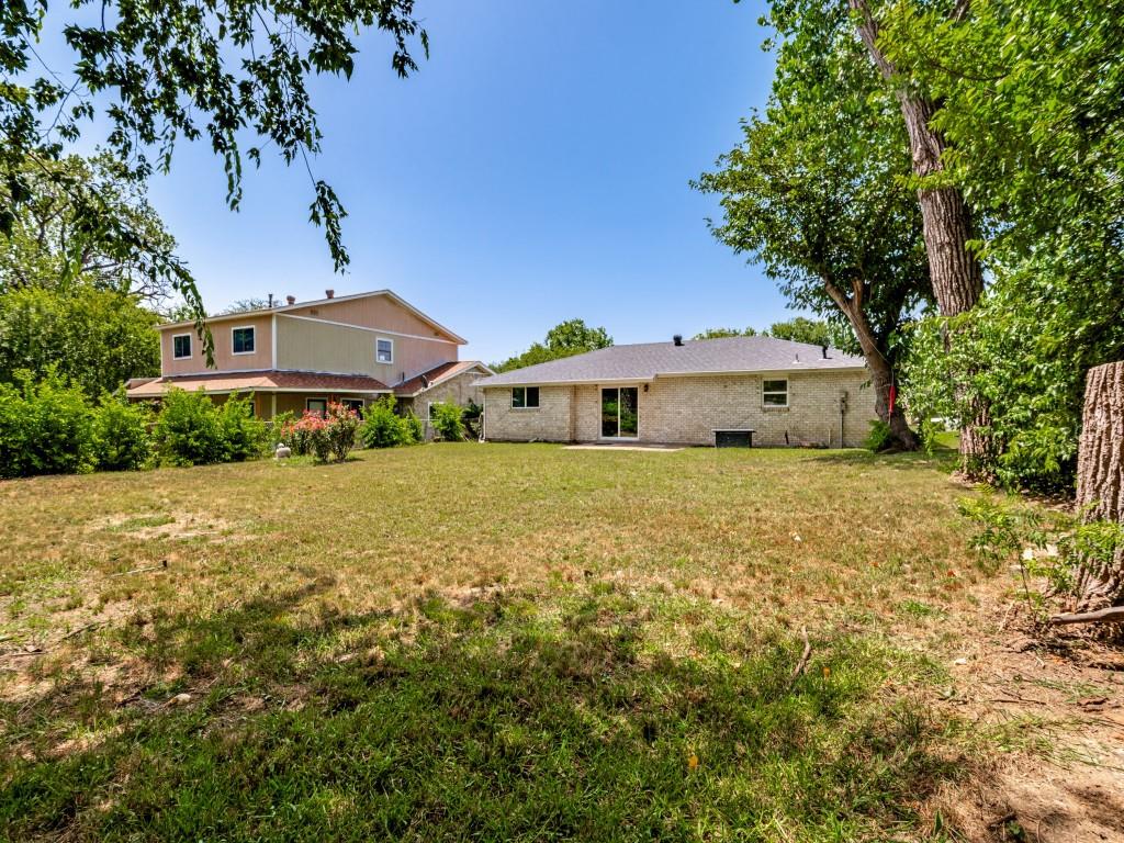 1405 Rambler Road Arlington, TX 76014 - Photo 24 of 26 Expansive rear yard featuring mature trees and a substantial lawn area