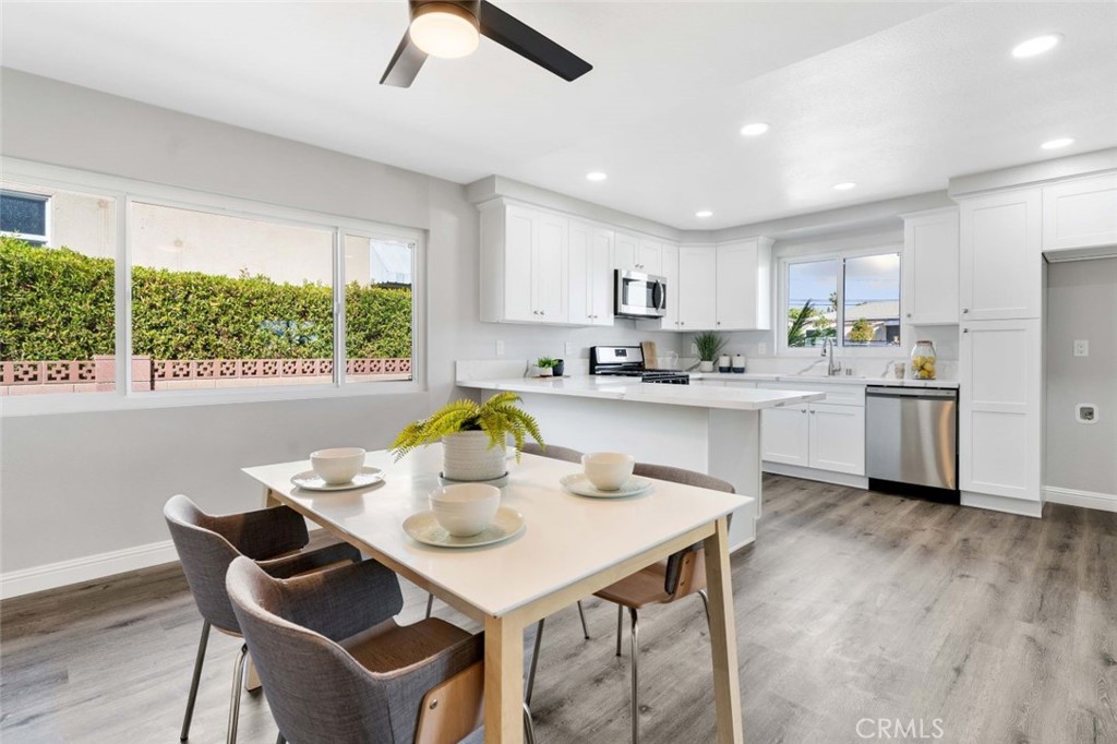 445 Via Val Verde Montebello, CA 90640 - Photo 12 of 51 a kitchen with a dining table chairs and window