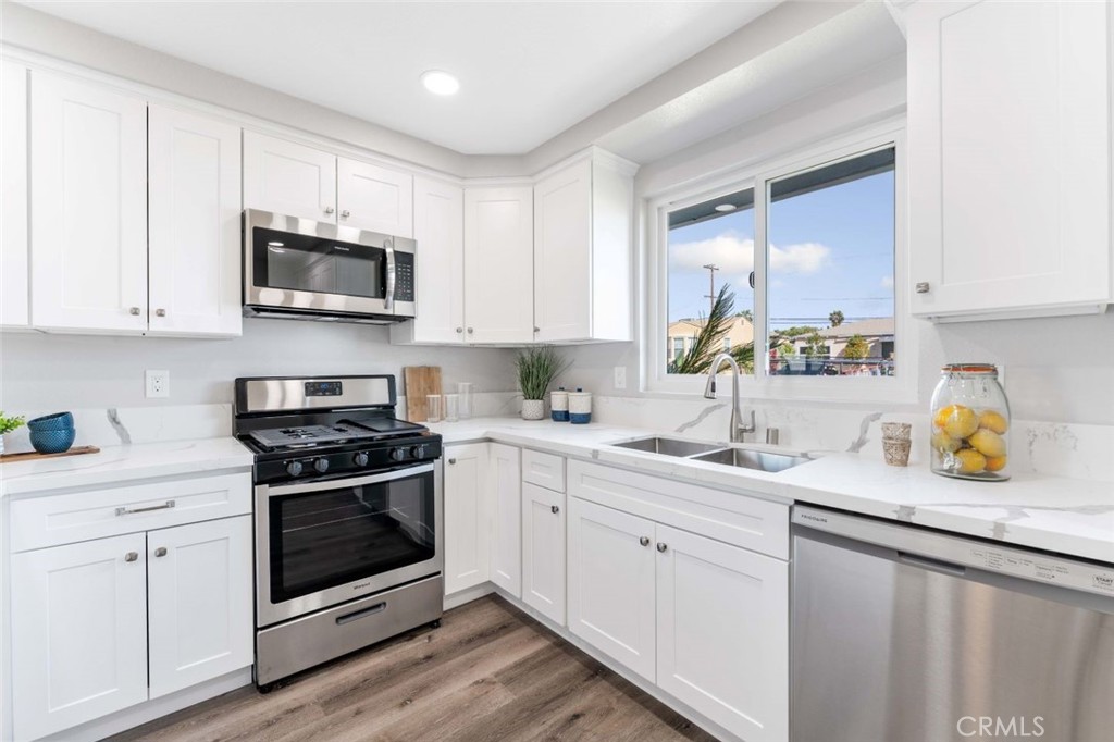 445 Via Val Verde Montebello, CA 90640 - Photo 15 of 51 a kitchen with stainless steel appliances granite countertop a sink a stove a microwave and cabinets