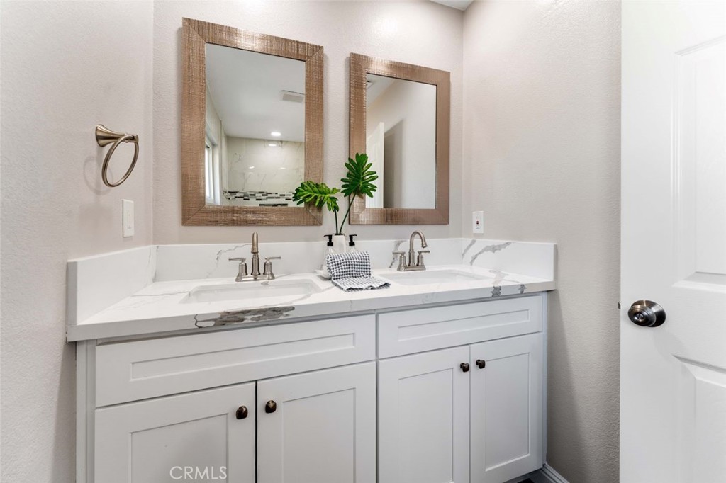 445 Via Val Verde Montebello, CA 90640 - Photo 21 of 51 a bathroom with a double vanity sink and a mirror
