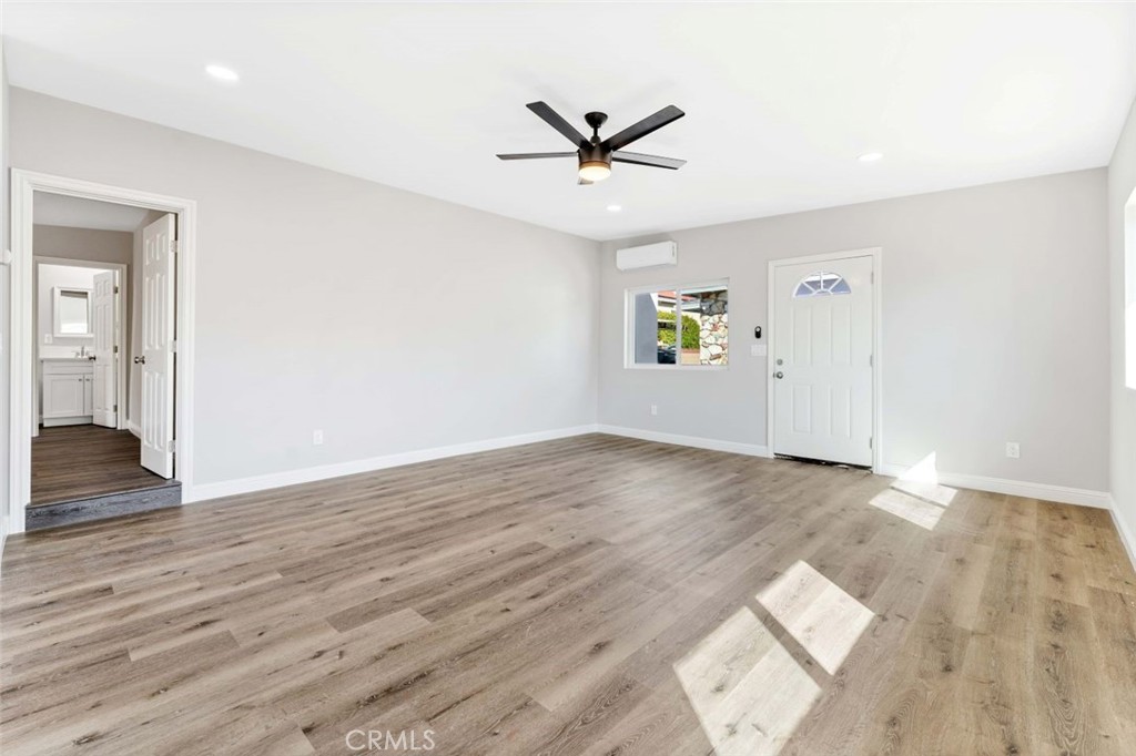 445 Via Val Verde Montebello, CA 90640 - Photo 29 of 51 an empty room with wooden floor a ceiling fan and windows
